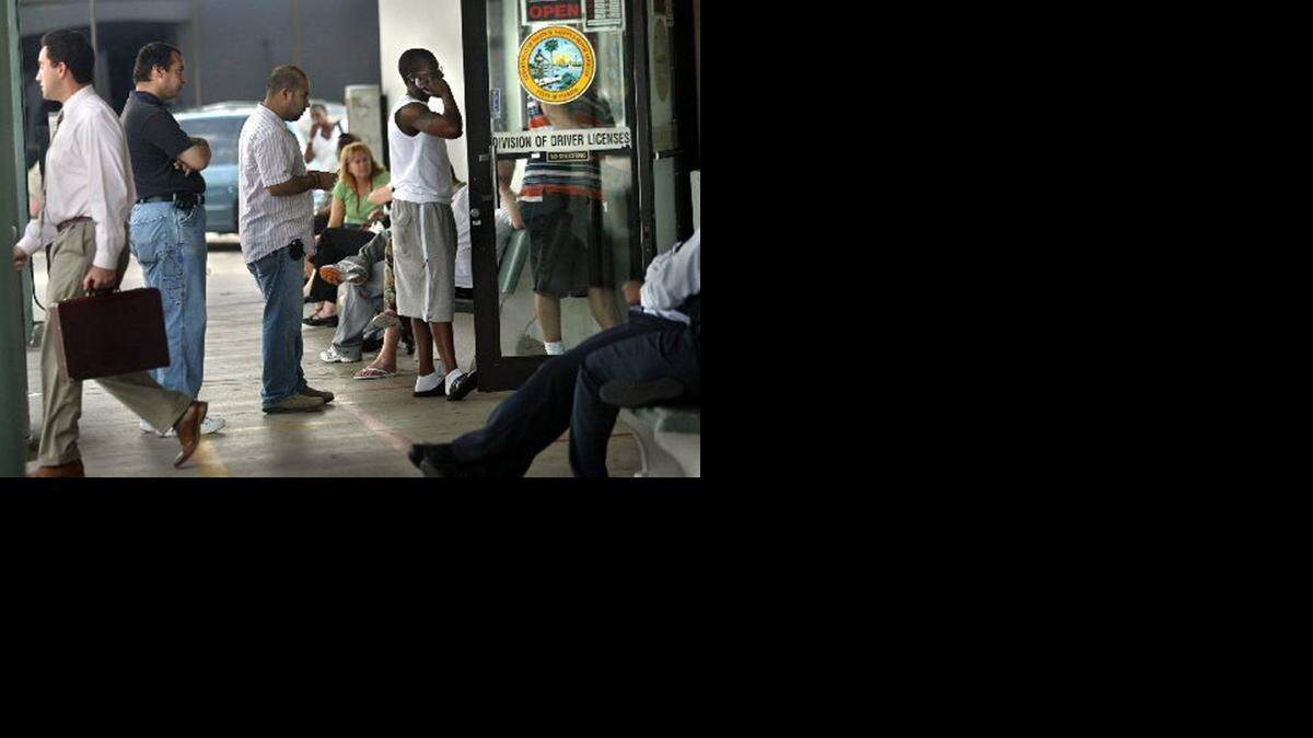 
People line up outside the Department of Motor Vehicles and Highway Safety in Lauderdale Lakes to get driver’s licenses. Advocates are campaigning to allow qualified Florida residents to get licenses regardless of immigration status.
