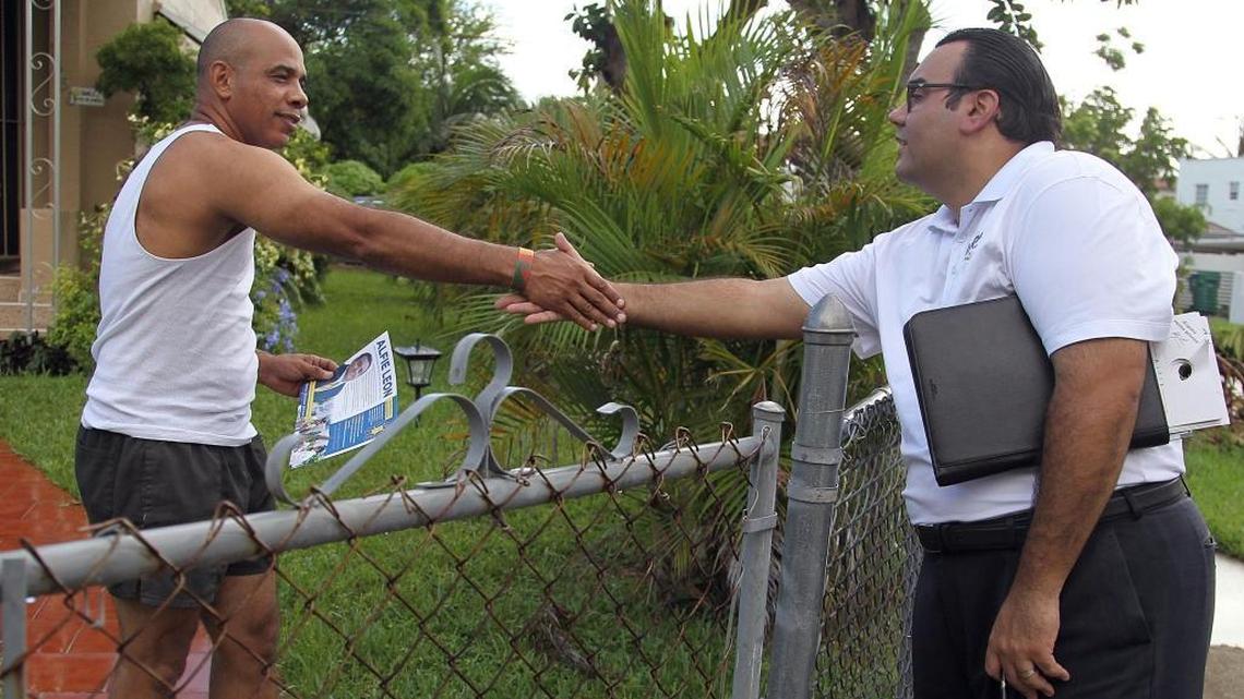 Miami Commission candidate Alfie Leon stops to talk with residents and hand out campaign materials as he walks through Miami’s Shenandoah and Roads neighborhoods on Oct. 3.