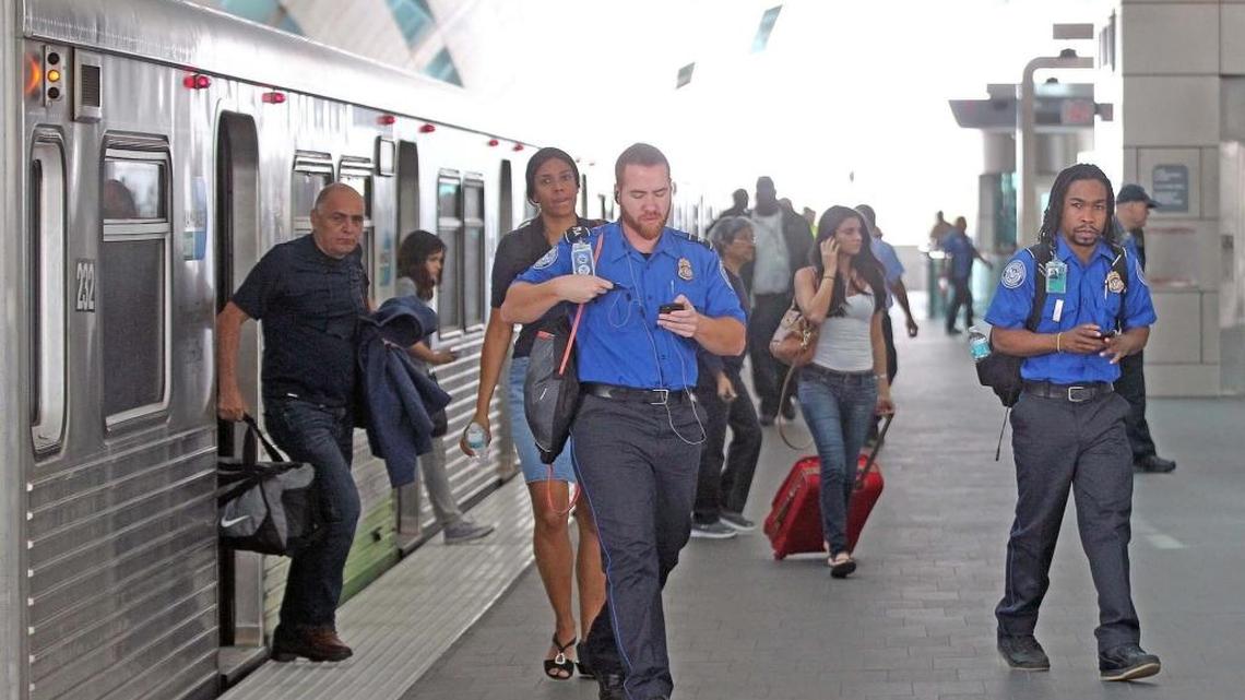 Airport passengers and commuters leave a Metrorail car at the station at Miami International Airport, the last stop on the roughly two miles of track added to the system 15 years after Miami-Dade voters approved a half-percent sales tax that was supposed to deliver a countywide expansion of the rail system.