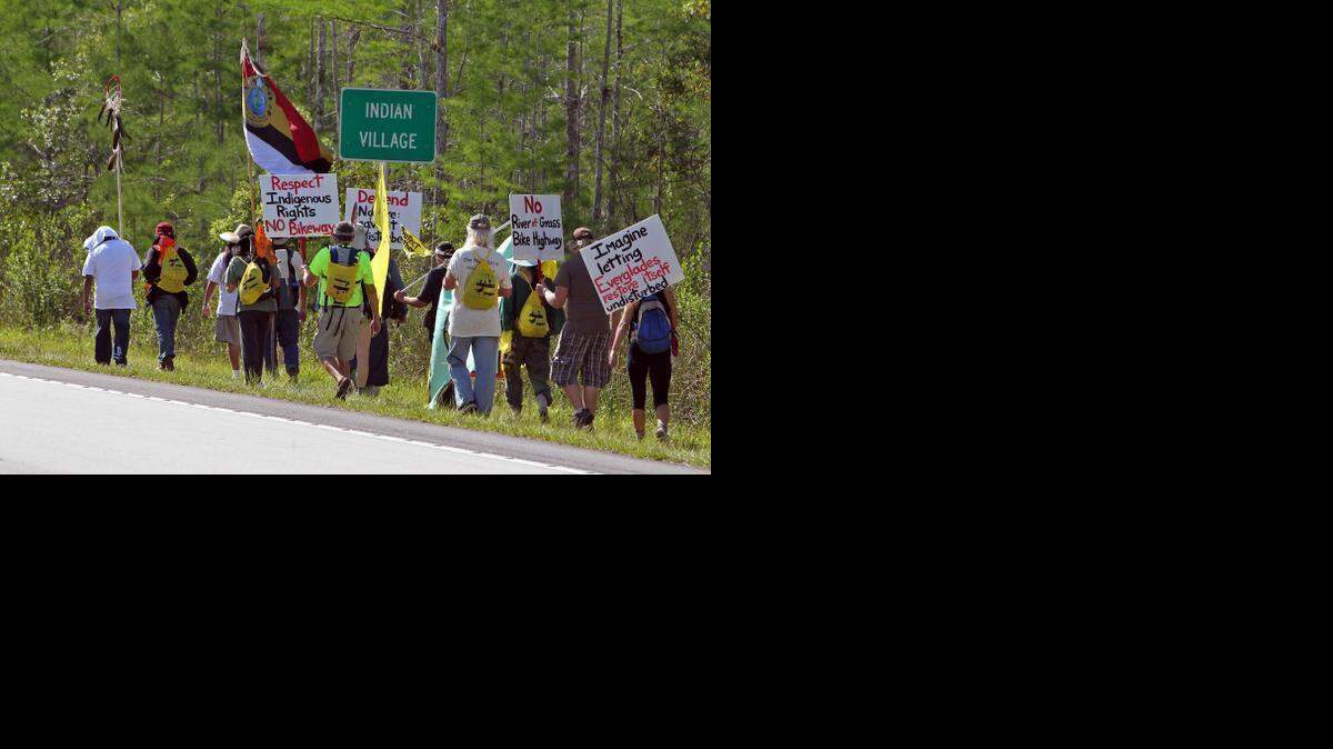 
Protestors of an Everglades bike path walk eastbound along Tamiami Trail on Wednesday.
