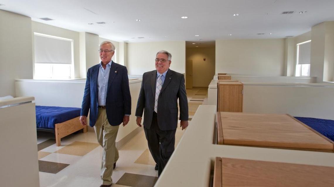 Camillus House Chairman Bob Dickinson, left, walks through a homeless facility with then-CEO Paul R. Ahr in this April 2013 file photo. Dickinson is now acting CEO of the charity after the suspension of Ahr’s successor, Shed Boren.