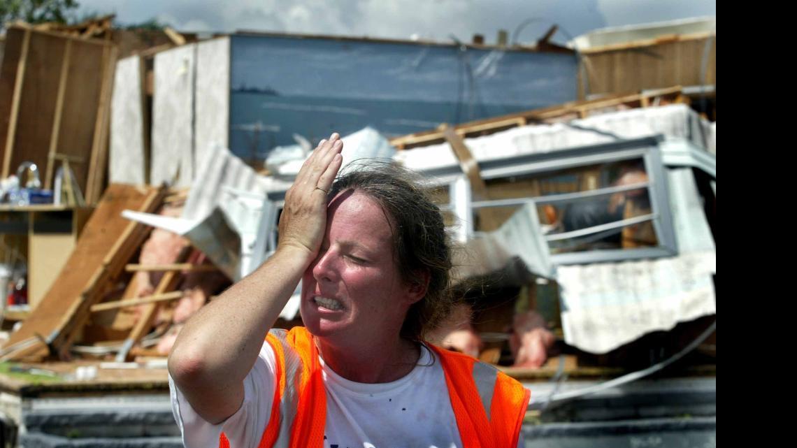 
Michelle Smith, 40, wipes her eyes as she got emotional while standing in front of her father Richard Smith's destroyed mobile home at Port Charlotte Village mobile home park in this Aug. 14, 2004 file photo. After nine seasons without a major hurricane striking the U.S., feds fear public will become complacent.
 

