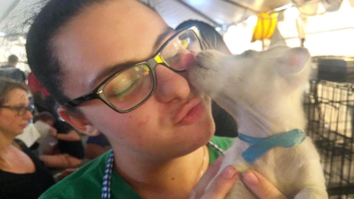 A Miami-Dade County Animal Services volunteer gets some love from an 8-week-old terrier puppy. He was up for grabs, like hundreds of other cats and dogs, at Saturday’s 24-hour Mega-Match-a-Thon pet adoption event.