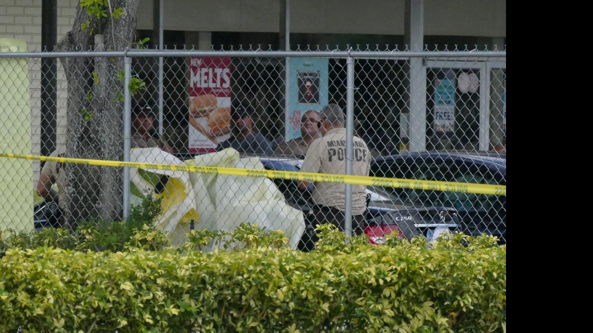 A woman was shot and killed in an apparent domestic dispute outside this 7-Eleven store on Northwest 103rd Street in North Miami-Dade on Friday, May 15, 2015.
