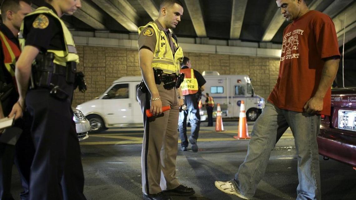 Florida Highway Patrol Trooper David Casillas, pictured here during a DUI checkpoint in 2006 in Miami, was arrested on Tuesday on allegations he helped a friend cover up a traffic crash.