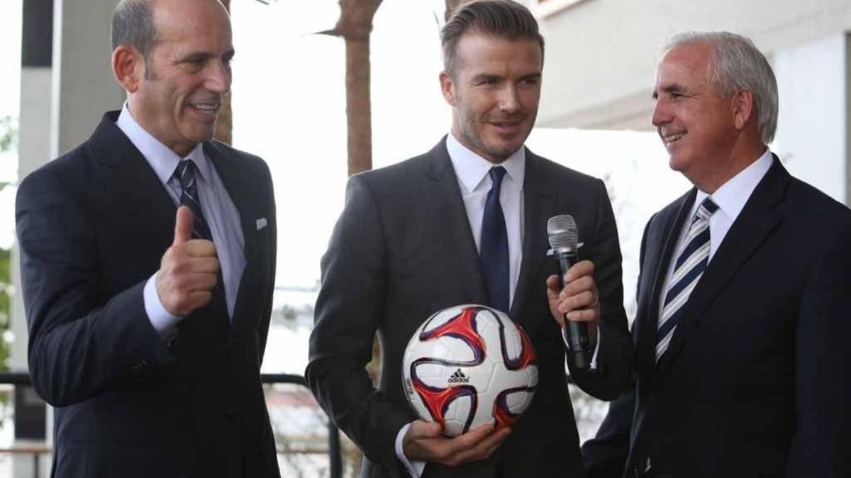 David Beckham takes a soccer ball from Miami-Dade Mayor Carlos Gimenez in a February 5, 2014, as Major League Soccer Don Garber at the Perez Art Museum Miami announcing Beckham’s pursuit of a Miami soccer stadium.