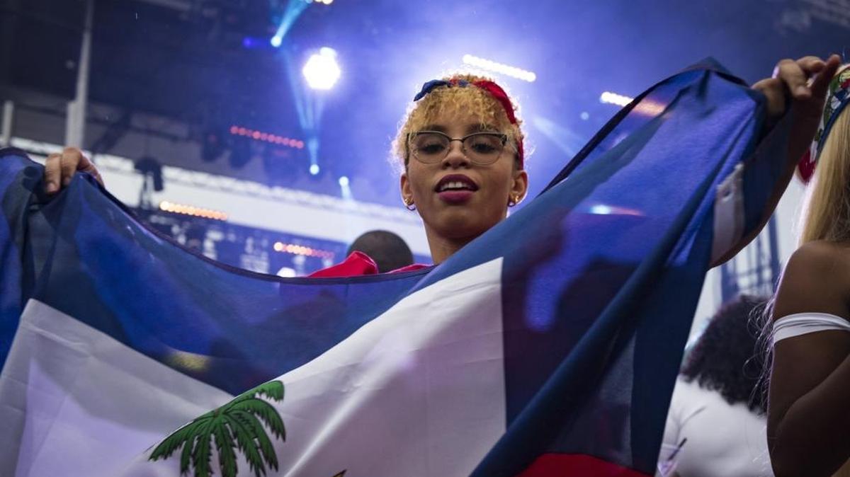 Kaysina Claudio dances with her Haitian flag in Miami on May 19, 2018.