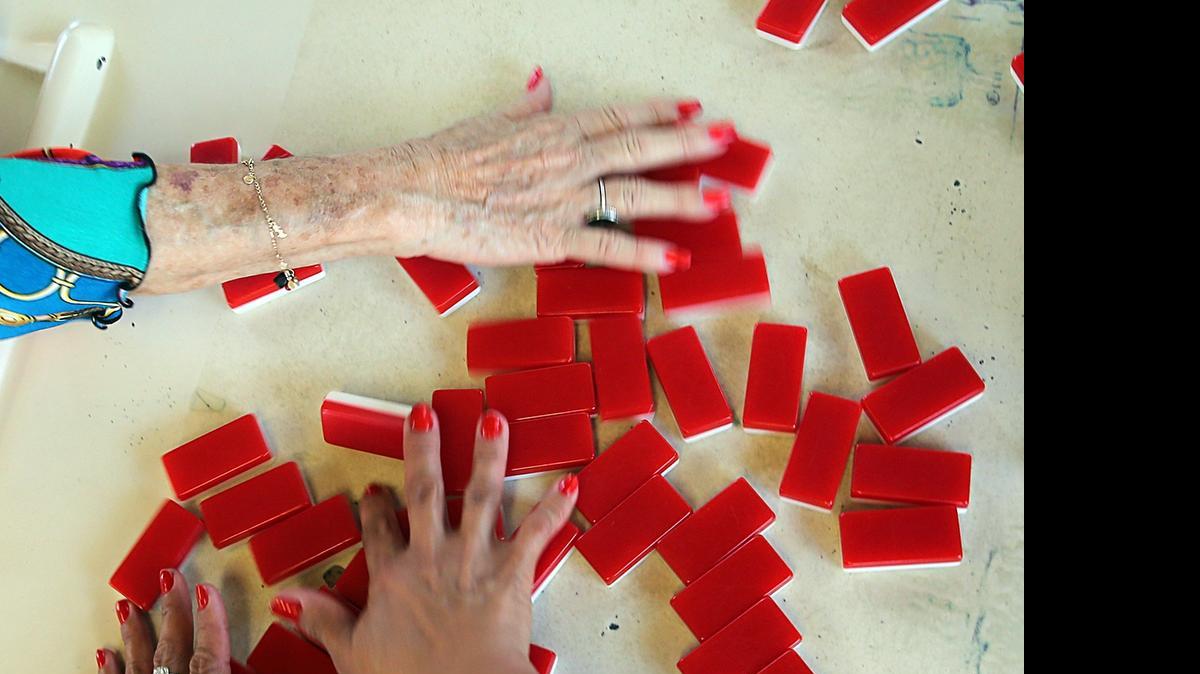 
Domino players pick their pieces as they get ready to start a match at Domino Park (Parque del Domino) in Little Havana.
