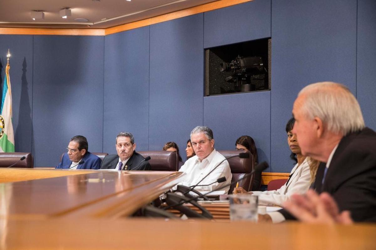 From left to right, Comissioners Xavier L. Suárez, José “Pepe” Díaz, Bruno A. Baneiro and county attorney Abigail Price-Williams listen to Miami-Dade County Mayor Carlos A. Giménez, far right, talk about the situation in Venezuela.