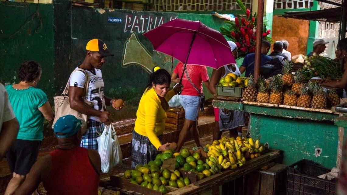 People shop at the El Egido food market in Havana, Cuba, in early December.