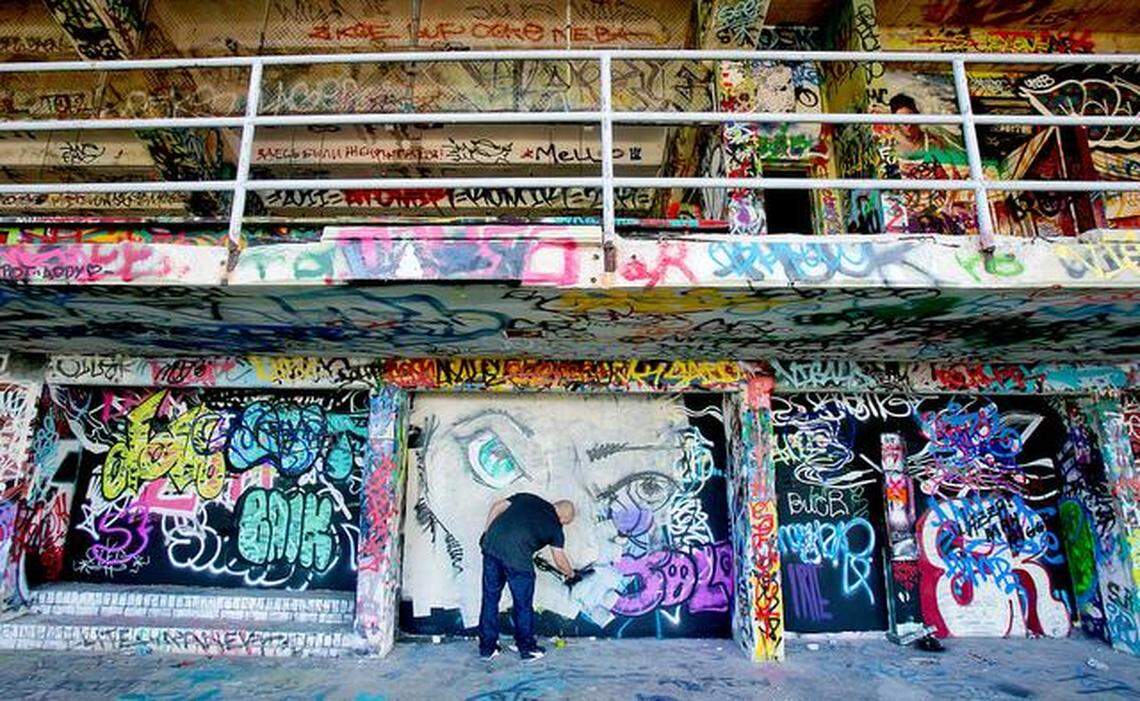 Artist Luis Berrios works on a wall at Miami Marine Stadium in 2014.