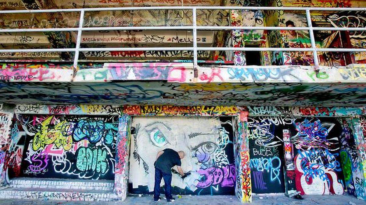 Artist Luis Berrios works on a wall at Miami Marine Stadium in 2014.