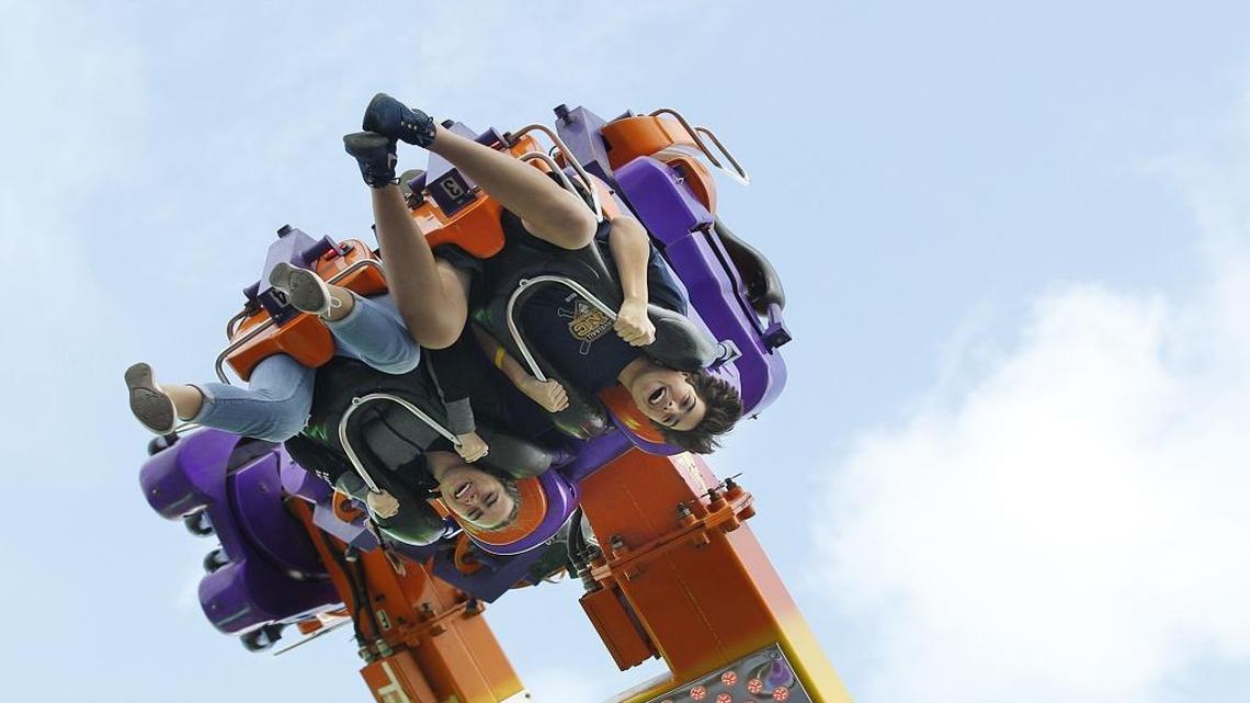 Fair goers enjoy a ride at Power Surge attraction during the Miami-Dade Youth Fair opening day, Thursday March 23, 2017.