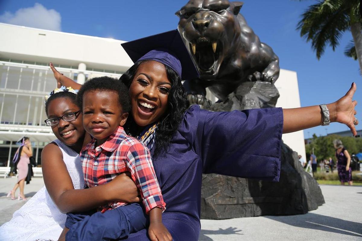 Nyamekye Daniel, 31, celebrates her graduation from Florida International University with her children Nyla Daniel, 11, left, and Braylon Betts, 1.