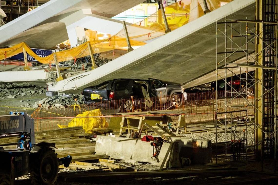 A pedestrian walkway connecting Florida International University to the city of Sweetwater fell, killing at least six Thursday. Cars remained trapped under the rubble on Southwest Eighth Street Friday.
