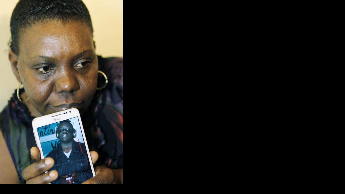 
LOST SON: Modesta Centeno holds a cellphone photo of her 14-year-old son, Gabriel Figueroa, who was shot and killed in a drive-by shooting Friday night in Liberty City.
