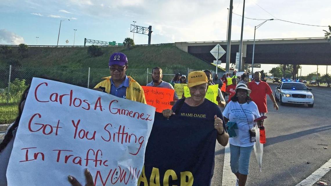 Participants in a “transit march” in South Dade head north on U.S. 1 on Monday. Led by Miami-Dade’s transit union, the event protested looming cuts in bus routes and the failure to extend rail to the southern parts of the county.