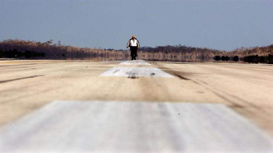 
Marc  Henderson, Airport Manager of the Everglades Jetport, walks a lonely runway in the Big Cypress Swamp where the training strip sits 28 miles west of Krome Ave. in this Jan. 3, 2002, file photo. 
