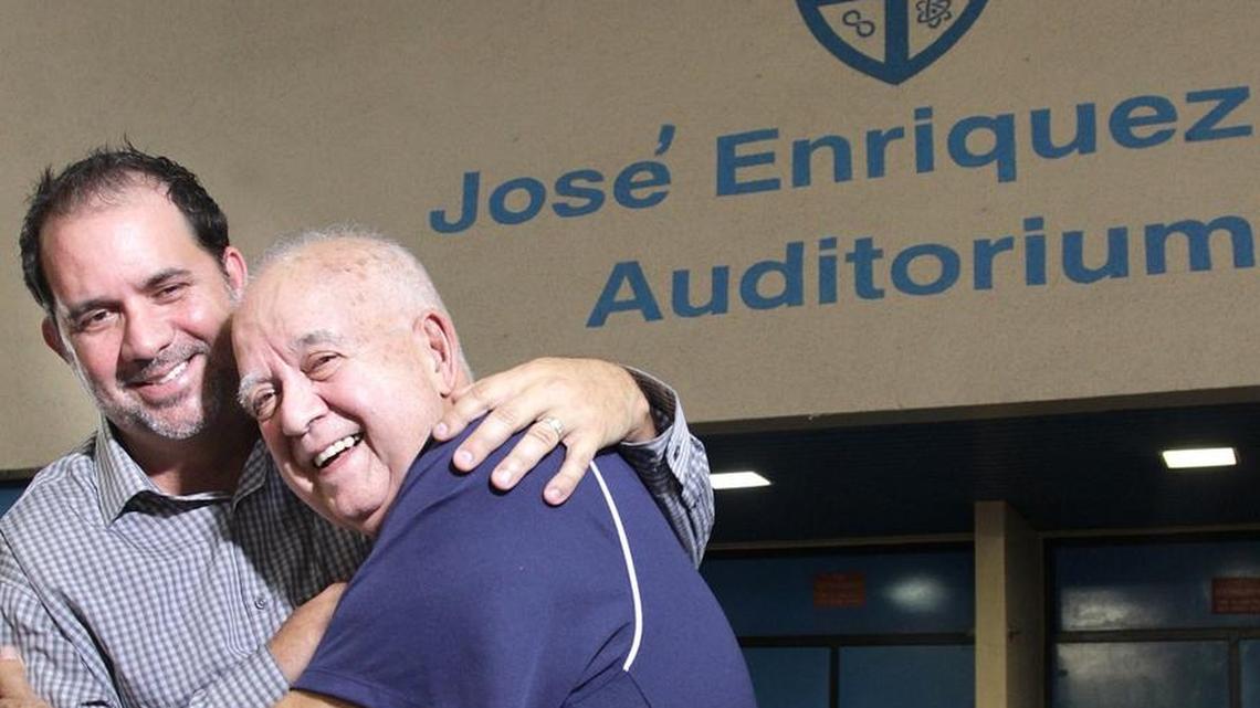 Jose Enriquez Jr., left, and his father, Jose Enriquez Sr., right, stand outside the auditorium that bares his father's name. Jose Enriquez Sr. was the founding principal of Jose Marti Junior High; his son is now the principal of the same school, which is now called José Martí MAST 6-12 Academy.