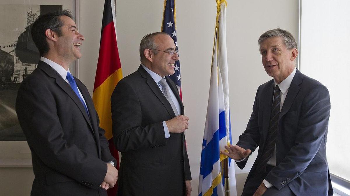 
German Consul General Juergen Borsch, at right, chats with Israeli Consul General Chaim Shacham, center, and Brian Siegal Regional Director of the American Jewish Committee, at the Isreali Consulate on Thursday July 29, 2015. They have worked together in planning events around the 50th anniversary of the diplomatic relationship beween Israel and Germany.
