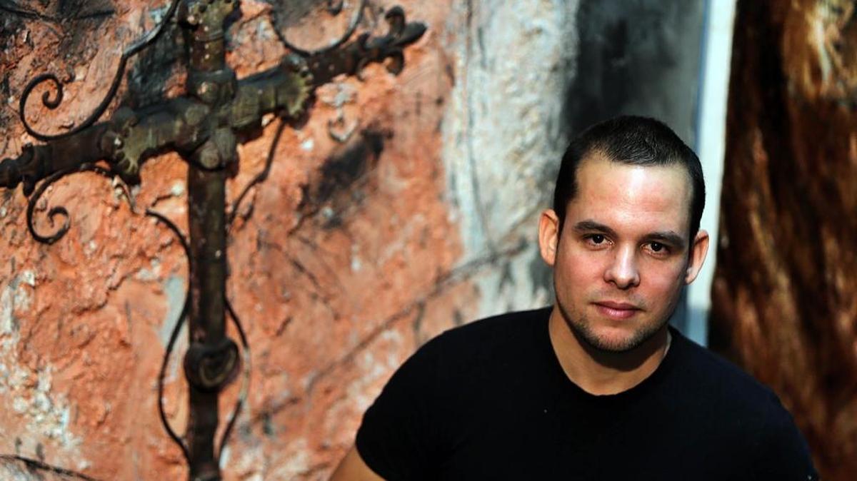 
Artist Yuniel Delgado Castillo, a recent Cuban immigrant, with a few of his works.
