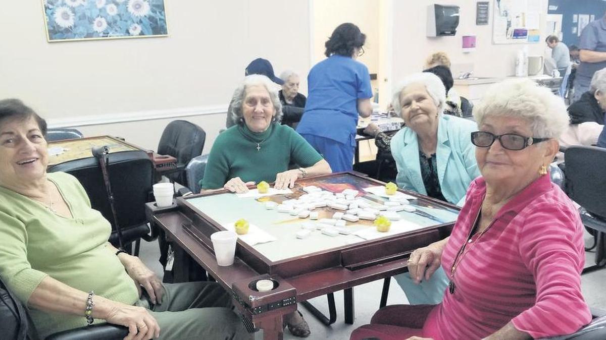 Luz Marina Fernandez, Edeberta Fernandez, Alejandrina Rodriguez and Georgina Gonzalez enjoy dominoes at the Hialeah branch of the Little Havana Activities and Nutrition Centers of Dade County. The group helps seniors stay social, and get health and nutrition checkups. There are 14 centers from Kendall to Miami Beach that provide free services. Photo by Luz Borges.