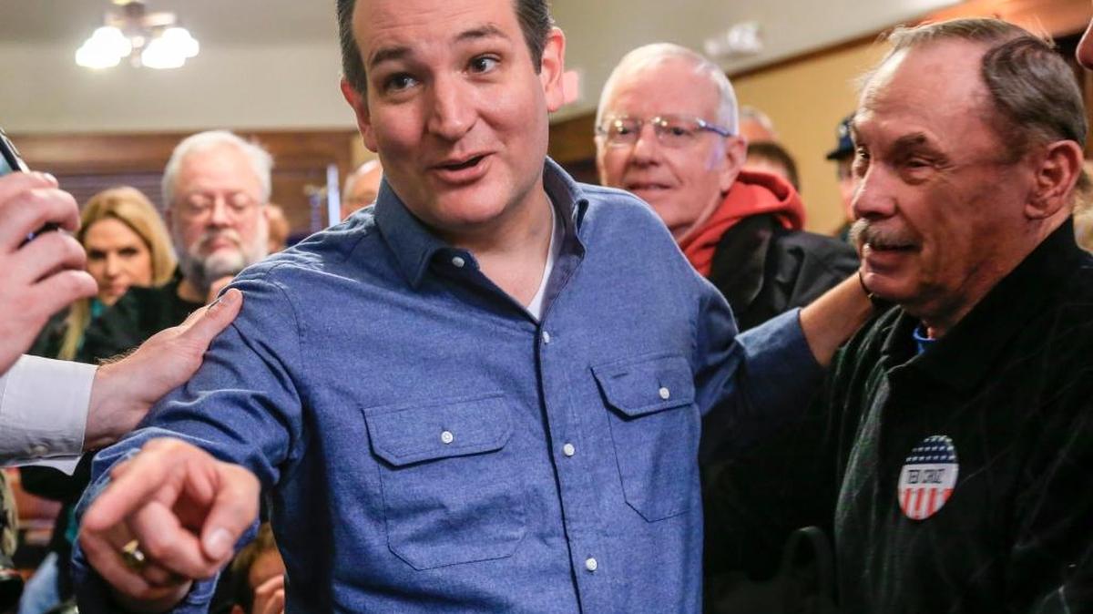 Republican presidential candidate Ted Cruz talks to a reporter while standing with supporter Court Oviatt after a campaign speech at the public library in Onawa, Iowa on Tuesday.