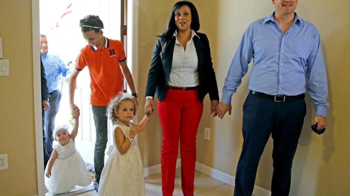 U.S. Army Specialist Matthew Trebilcock, his wife Leonor and their three children enter their new house in Homestead, Oct. 29, 2015. They received a mortgage-free house, provided by Building Homes for Heroes and Chase Bank.