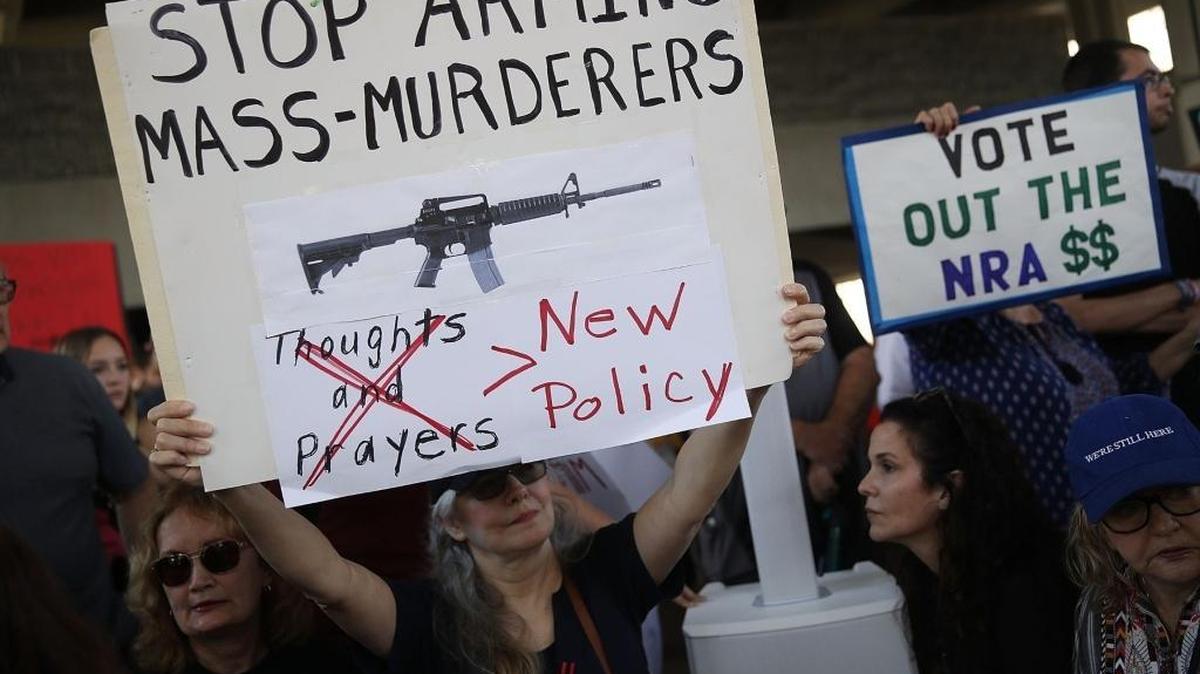 People join together after a school shooting that killed 17 to protest against guns on the steps of the Broward County Federal courthouse on February 17, 2018, in Fort Lauderdale, Florida. One month after the shooting, the City of Miami has empowered its attorney to challenge the state’s law prohibiting municipalities from passing their own gun ordinances.
