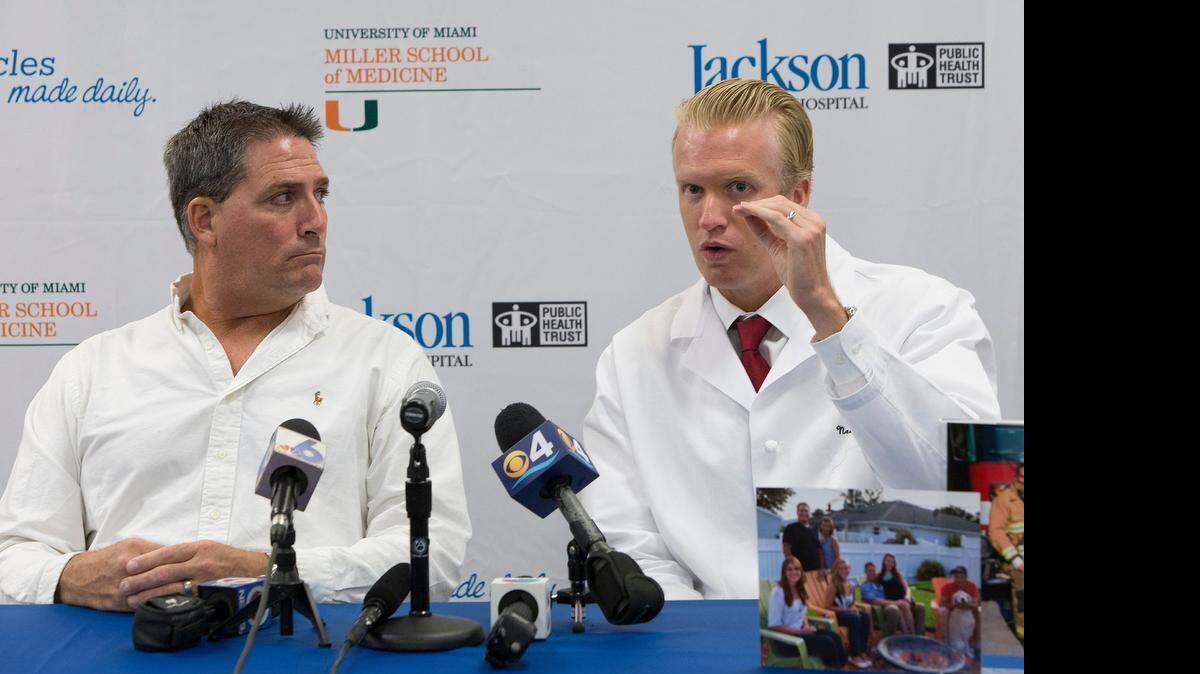 
UHealth neurosurgeon Dr. Eric Peterson, right, explains how he performed surgery on Indian River County firefighter Lt. Daniel Brooks, left, at Jackson Memorial Hospital.


