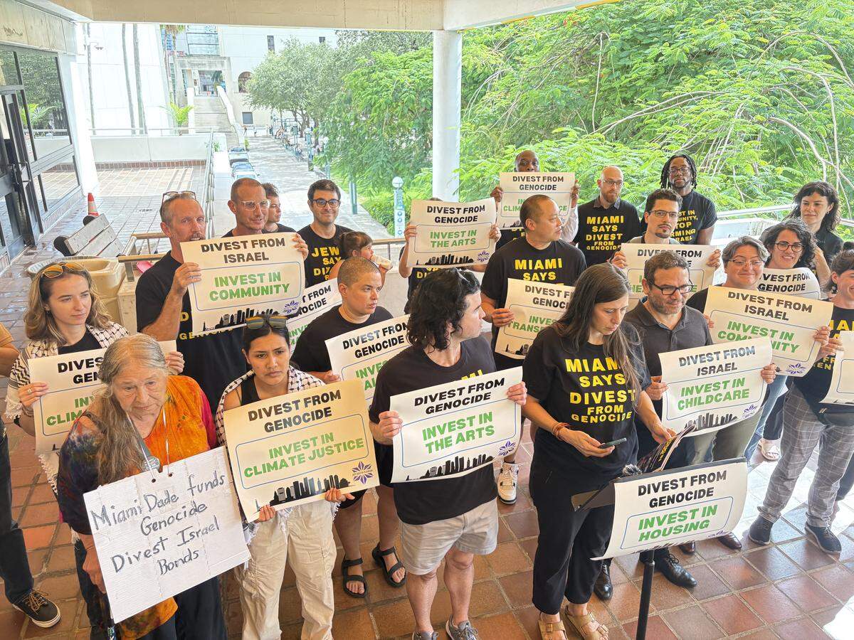 At the Stephen P. Clark Center on Thursday, Sept. 18, 2025, critics of Miami-Dade County’s investment in Israel bonds gathered to condemn the holdings as supporting genocide. (Backers of the county’s bond Israel bonds reject that criticism, calling them safe investments that don’t carry endorsement of actions by the Israel government.) While he didn’t speak, the son of Miami-Dade’s mayor stood behind the speakers and spoke with a reporter about his disagreement with his mother.