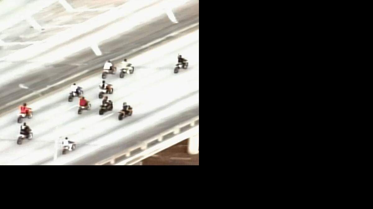 
Dirt bike riders drive on southbound I-95 Monday afternoon, popping wheelies and weaving in between cars.

