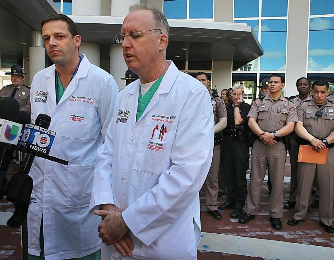 Doctors Gerd Daniel Pust, left, and Carl I. Schulman, both from the Ryder Trauma Center, talked to the press as a group of Florida Highway Patrol officers gathered outside Jackson Memorial Hospital after their colleague Trooper Carlos Rosario, a 12-year veteran of the force, was struck around 9:30 a.m. on the Dolphin Expressway, in Miami, on Friday March 17, 2017.