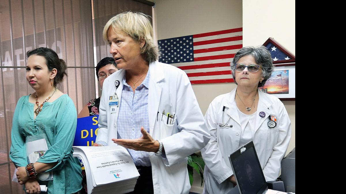 
Martha Baker (center), president of SEUI Local 1991, delivers 30,000 signatures in support of Medicaid expansion to the Hialeah office of state Rep. Jose Oliva. Hialeah ZIP code 33012, which is in his district, has the highest Affordable Care Act enrollment in the nation, yet Oliva opposes expansion — a provision of the ACA.
