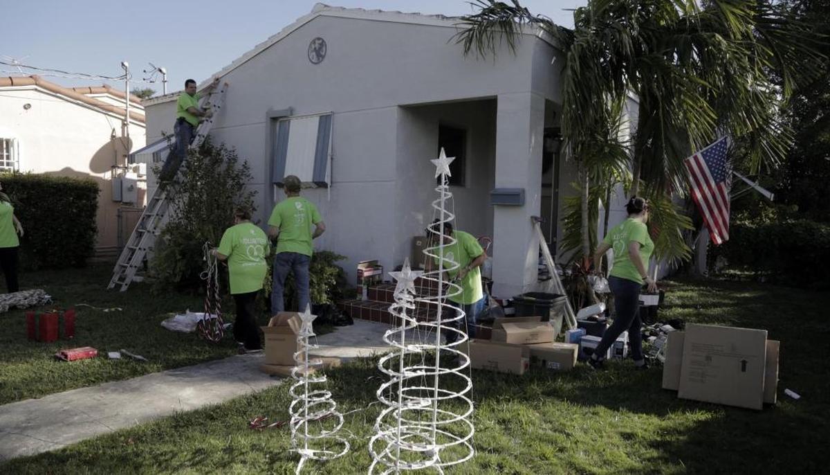 FPL volunteers install lights on the house of retired Marine Corp. Lt. Colonel Patrick McMullan. The veteran and his family received a special holiday surprise when Florida Power & Light transformed their home into an energy-efficient winter wonderland on Tuesday, Dec. 5, 2017.