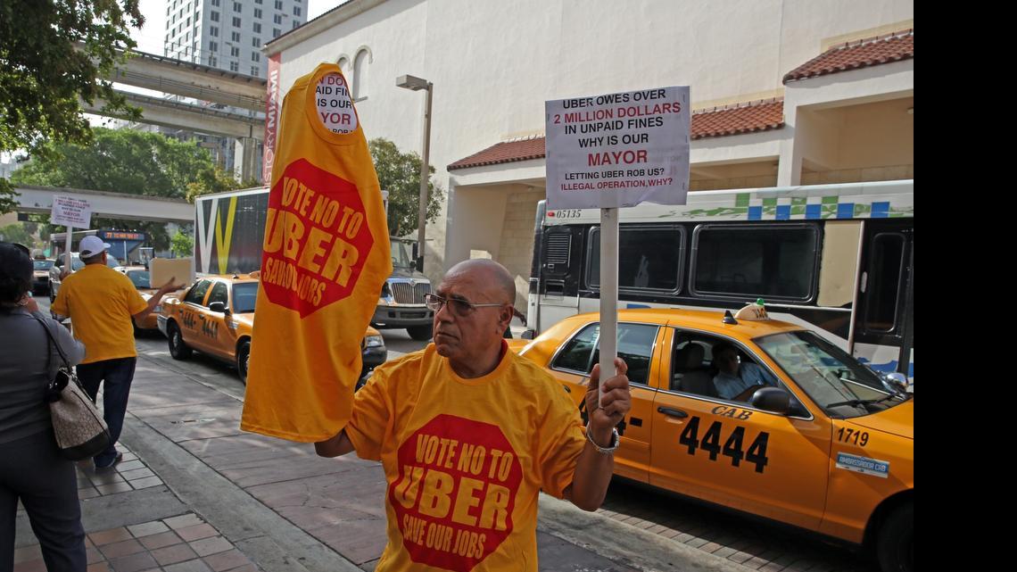 
Shalom Hamami, a taxi driver and owner in Broward and Miami-Dade, on Tuesday protests Uber's continuing presence in Miami-Dade.

