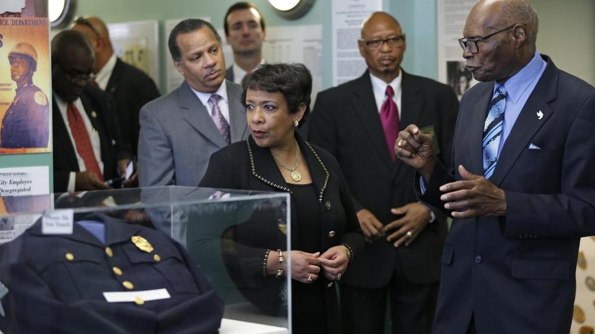 Attorney General Loretta Lynch arrives at the Black Police Precinct and Courthouse Museum in Overtown on Friday. At left is her husband Stephen Hargrove and leading the tour, at right, is retired Miami Police Lieutenant Archie McKay.