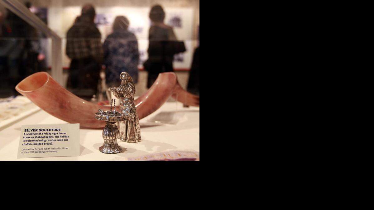 
This is a silver sculpture of a Friday night home scene as Shabbat begins, and is one of the sacred objests at the Coral Gables Museum The new exhibit illustrates the 66-year history of Temple Judea through video, historical photographs, documents and sacred objects.
