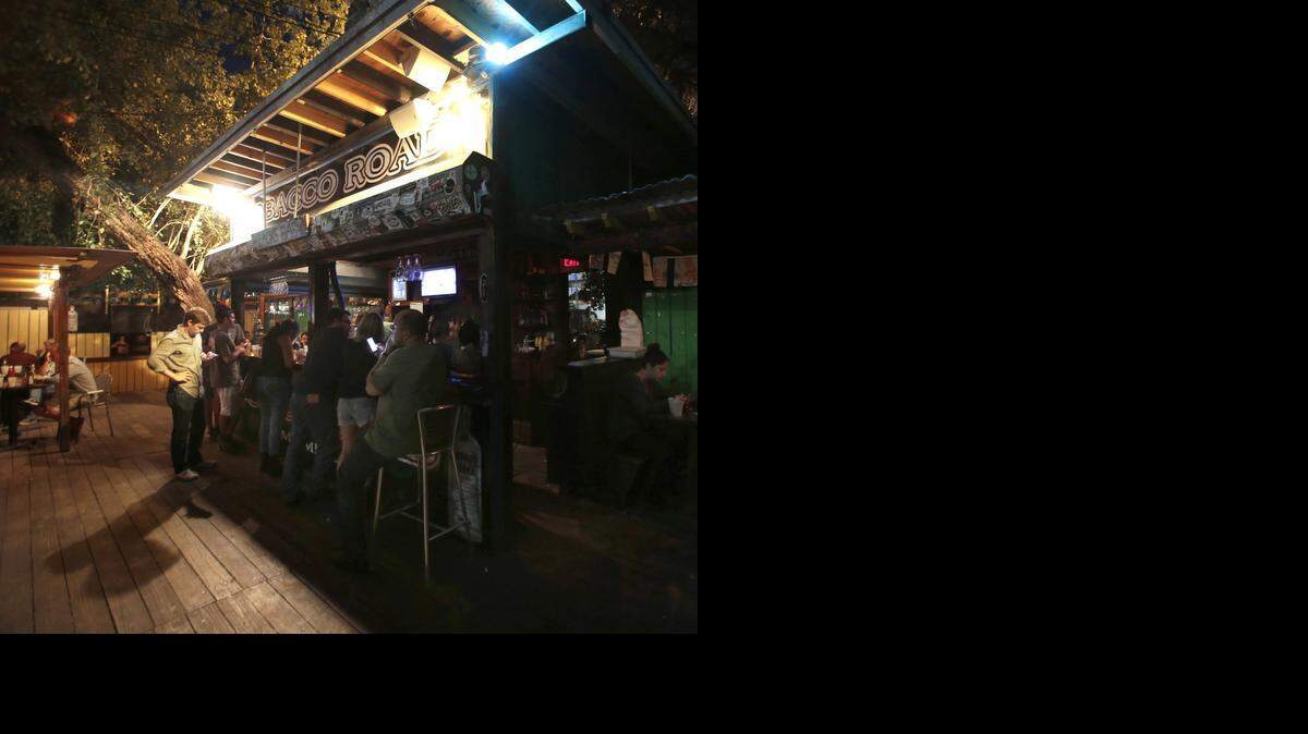
Customers gather at the bar before the historic Tobacco Road closes its doors. Former New Times employees gathered at Tobacco Road for small reunion to catch up and reminisce about the old days when their office was on the second floor near the bar.
