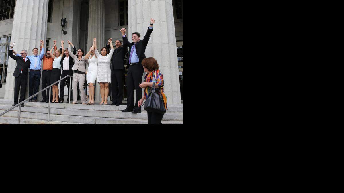 
Same-sex couples and their attorneys in Miami celebrate Circuit Court Judge Sarah Zabel’s decision to lift the legal stay she had placed on her July decision declaring Florida’s gay-marriage ban unconstitutional.
