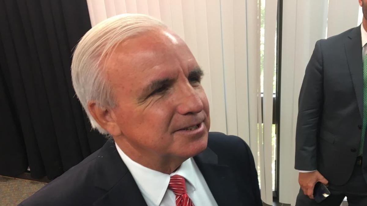Miami-Dade Mayor Carlos Gimenez talks to reporters at County Hall in downtown Miami on Tuesday.