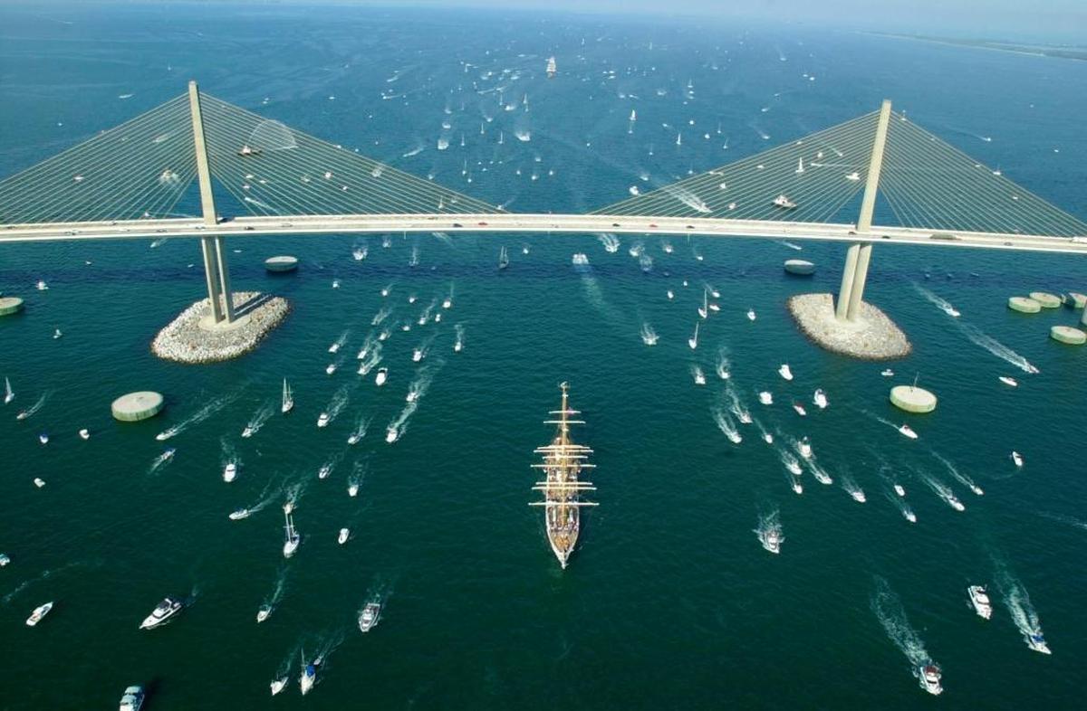 The U.S. Coast Guard Barque Eagle, center, sails under the Sunshine Skyway Bridge in Hillsborough County, Fla., in 2002, during the Parade of Sail headed to St. Petersburg.