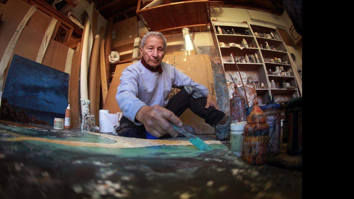 
Baruj Salinas works at his art studio in southwest Miami. The artist is working on paintings that form part of the Torah project, celebrating the 50th anniversary of The Shrine of the Book, a building that occupies a wing in the Museum of Israel in Jerusalem and houses important historical documents such as scrolls about the Dead Sea.
