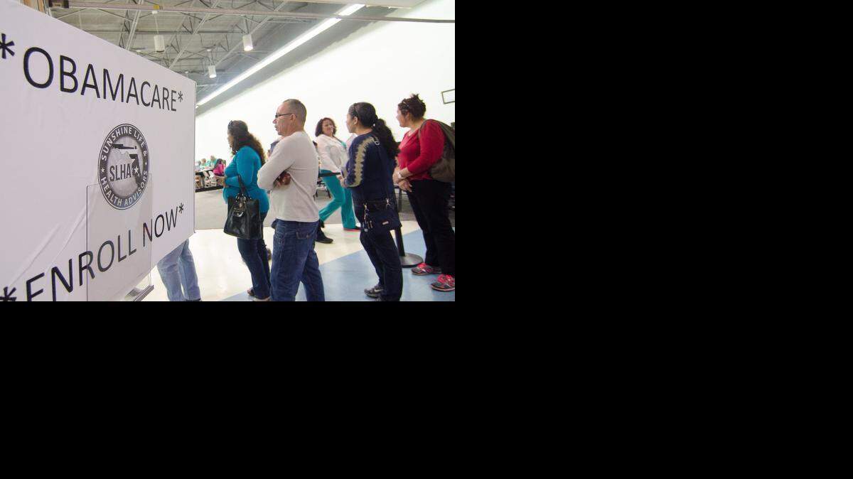 
Applicants line up outside the Sunshine Life & Health Advisors at a store setup in the Mall of the Americas on December 15, 2014 in Miami. 
