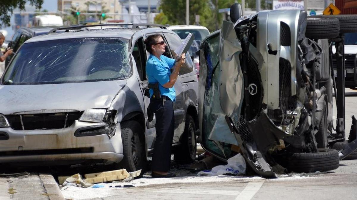 
An overturned Mazda van transporting students from Green Springs High School, collided with a Nissan Sentra at the intersection of Northwest Seventh Street and 35th Avenue, Wednesday, September 30, 2015. The overturned van hit this parked van after colliding with the Sentra.
