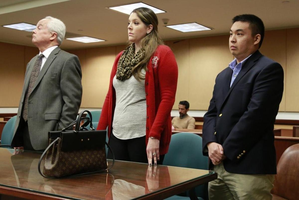 Alex Zhang, at right, stands with attorneys at a hearing in Miami-Dade court in January. He is suspected of posting hundreds of photos of his female classmates on fetish websites. Two classmates are trying to get a permanent restraining order against him.
