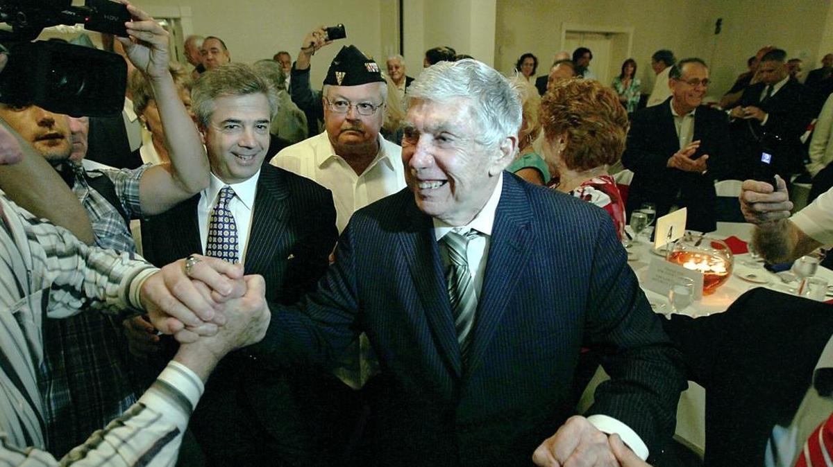In this April 2011 file photo, supporters welcomed Luis Posada Carriles, followed by his lawyer Arturo Hernandez, during a dinner organized by Cuban exiles to honor him after he was acquitted in the Texas perjury case.