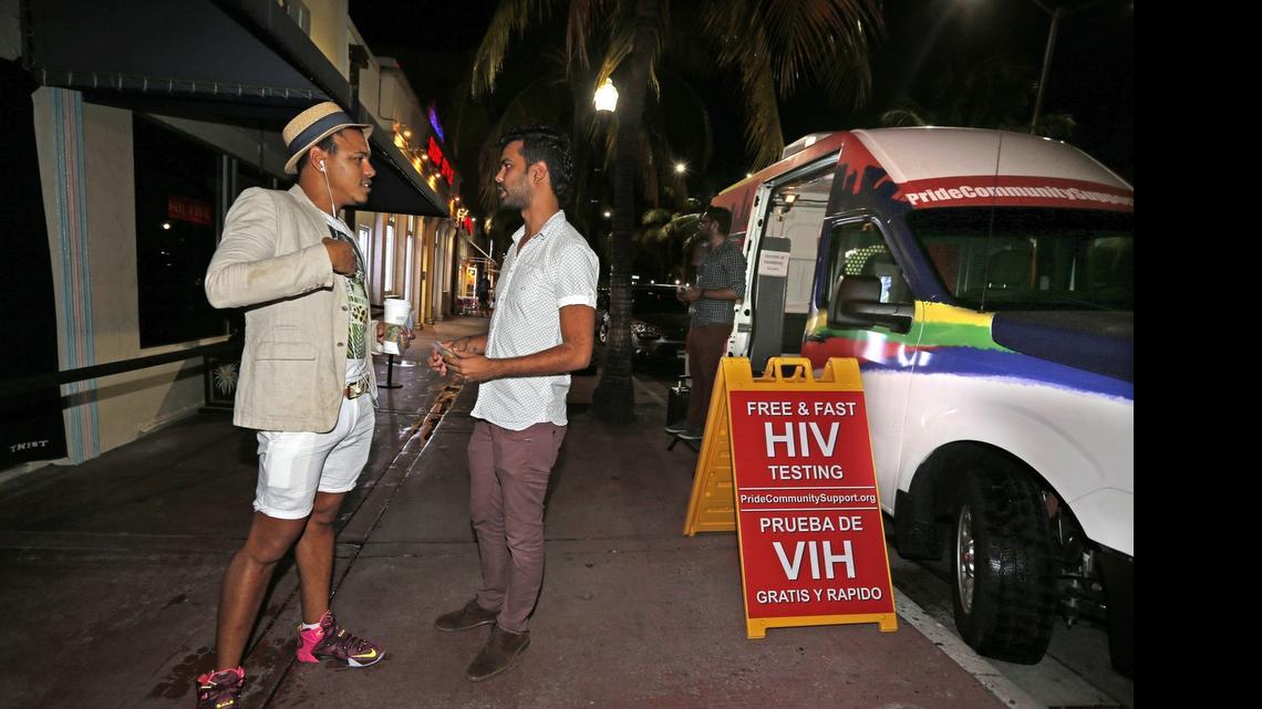 
Jose Javier of Latinos Salud talks with a clubgoer outside of Twist night club on South Beach, July 22, 2015. Latinos Salud is an advocacy group that provides rapid HIV testing, safe sex education and free condoms. They recently started working in the area with the support of local nightclubs after South Beach AIDS Project shut down. This month, they've been able to expand to having a full-time presence.
