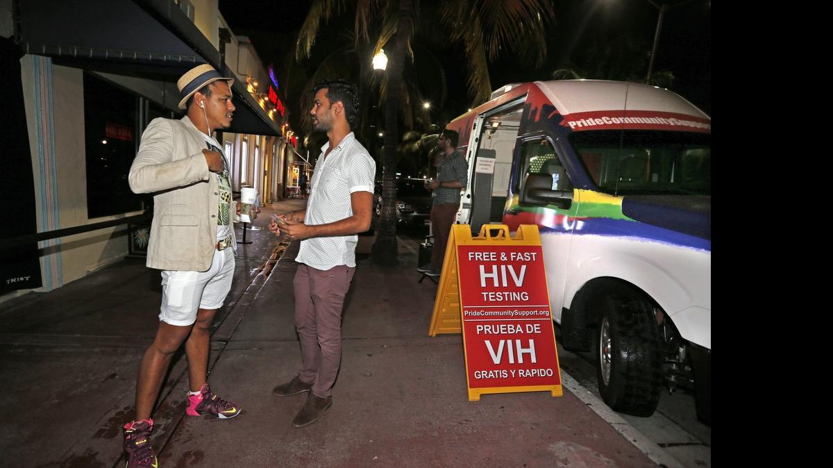 
Jose Javier of Latinos Salud talks with a clubgoer outside of Twist night club on South Beach, July 22, 2015. Latinos Salud is an advocacy group that provides rapid HIV testing, safe sex education and free condoms. They recently started working in the area with the support of local nightclubs after South Beach AIDS Project shut down. This month, they've been able to expand to having a full-time presence.
