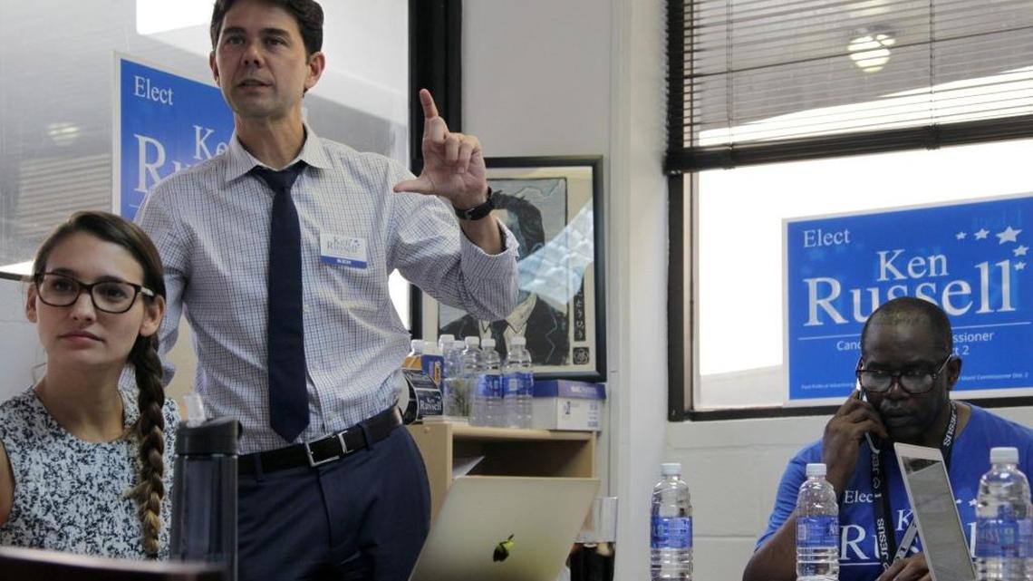 
On Wednesday, Oct. 14, 2015 Miami Commission District 2 candidate, Ken Russell, center, work on campaign planning with his staff members as Daniela Martins, campaign coordinator, left, listens and Gerald Tinker, volunteer, works on the phone.
